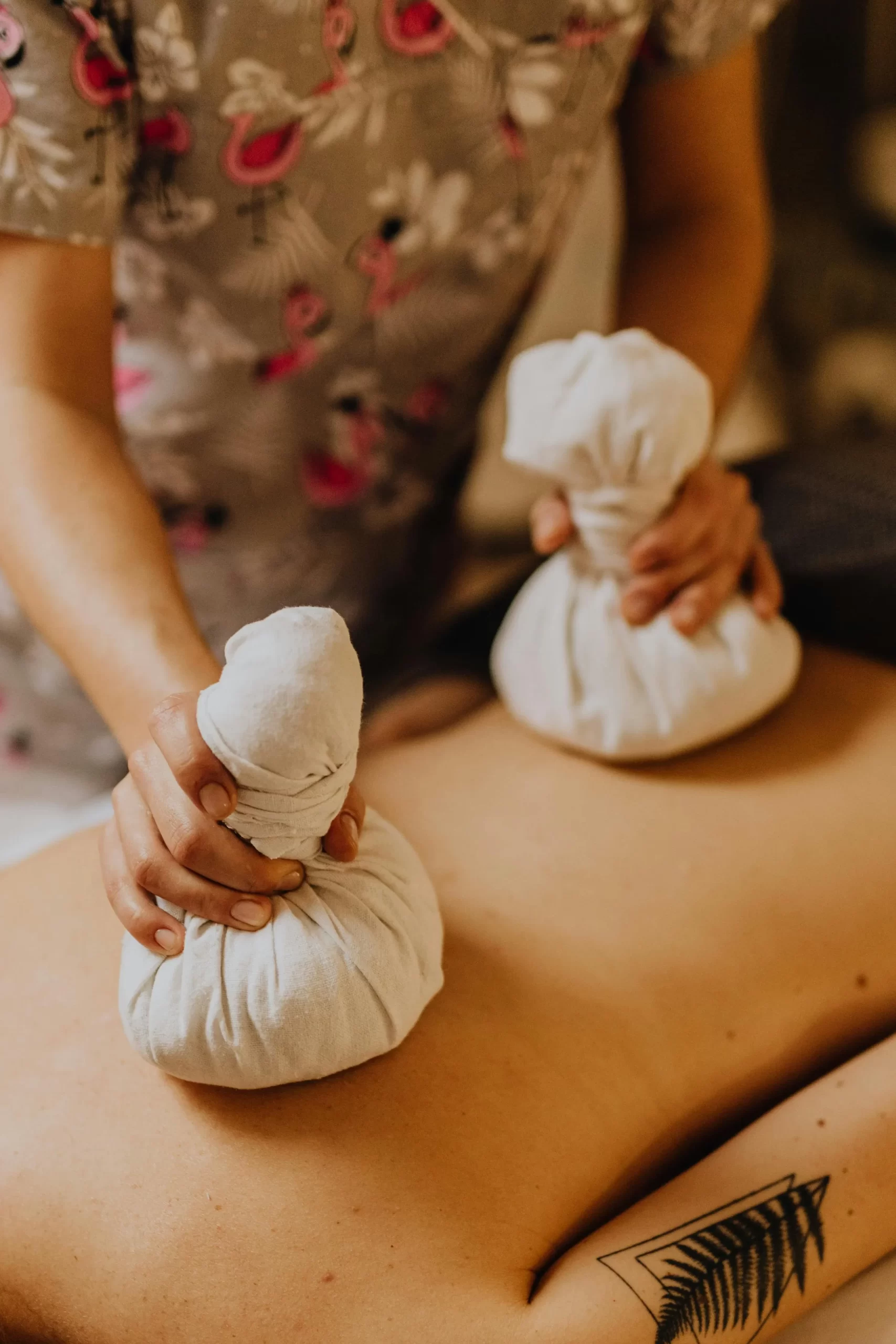  Client enjoying a hot stone massage at Jina Thai Massage to relieve stress and tension.